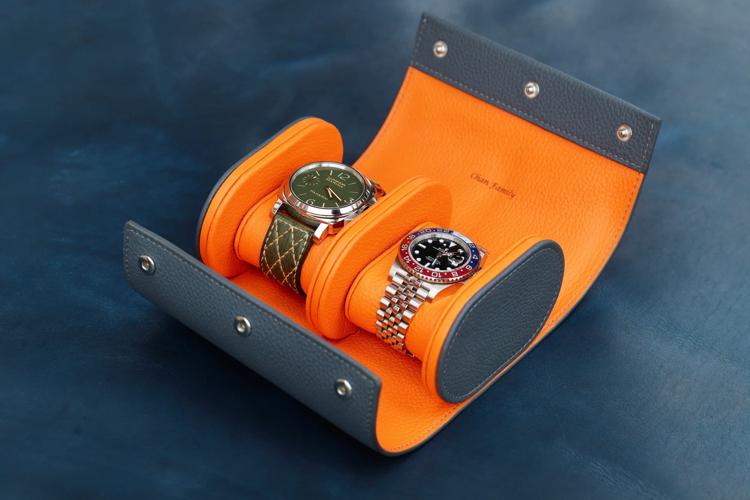 An open leather watch roll displaying several watches, ready to gift.