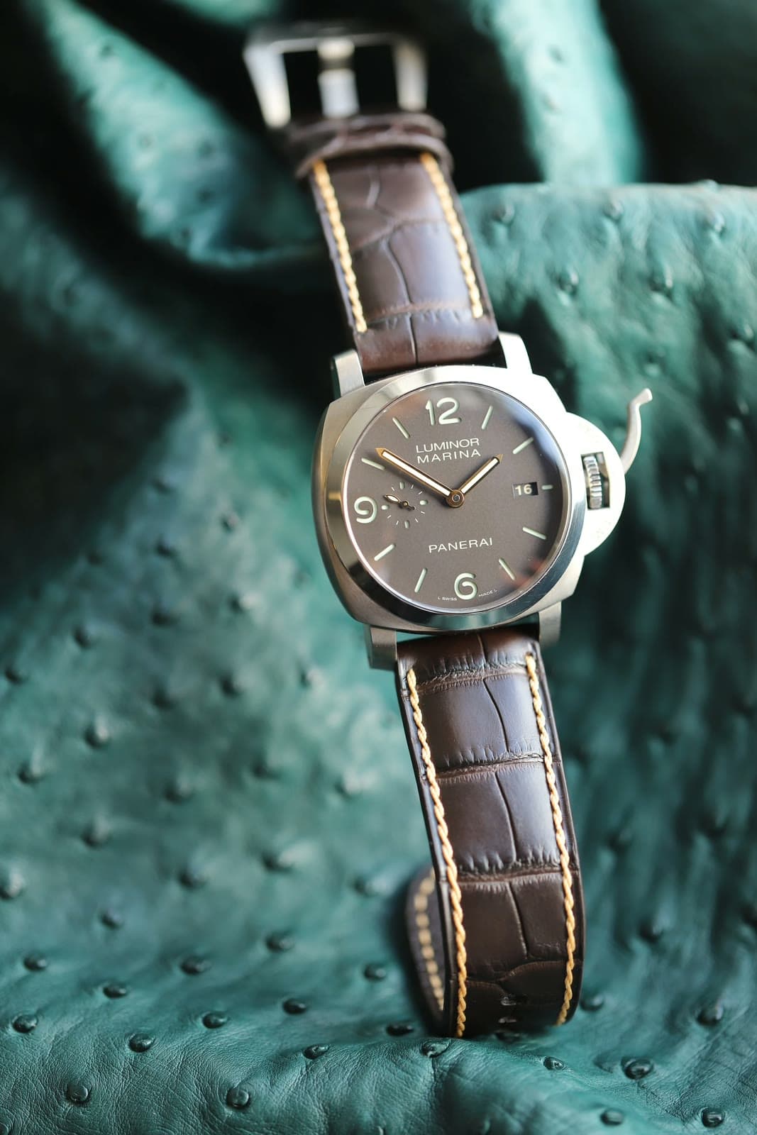 A Panerai on a brown alligator strap with cream contrast saddle-stitching.