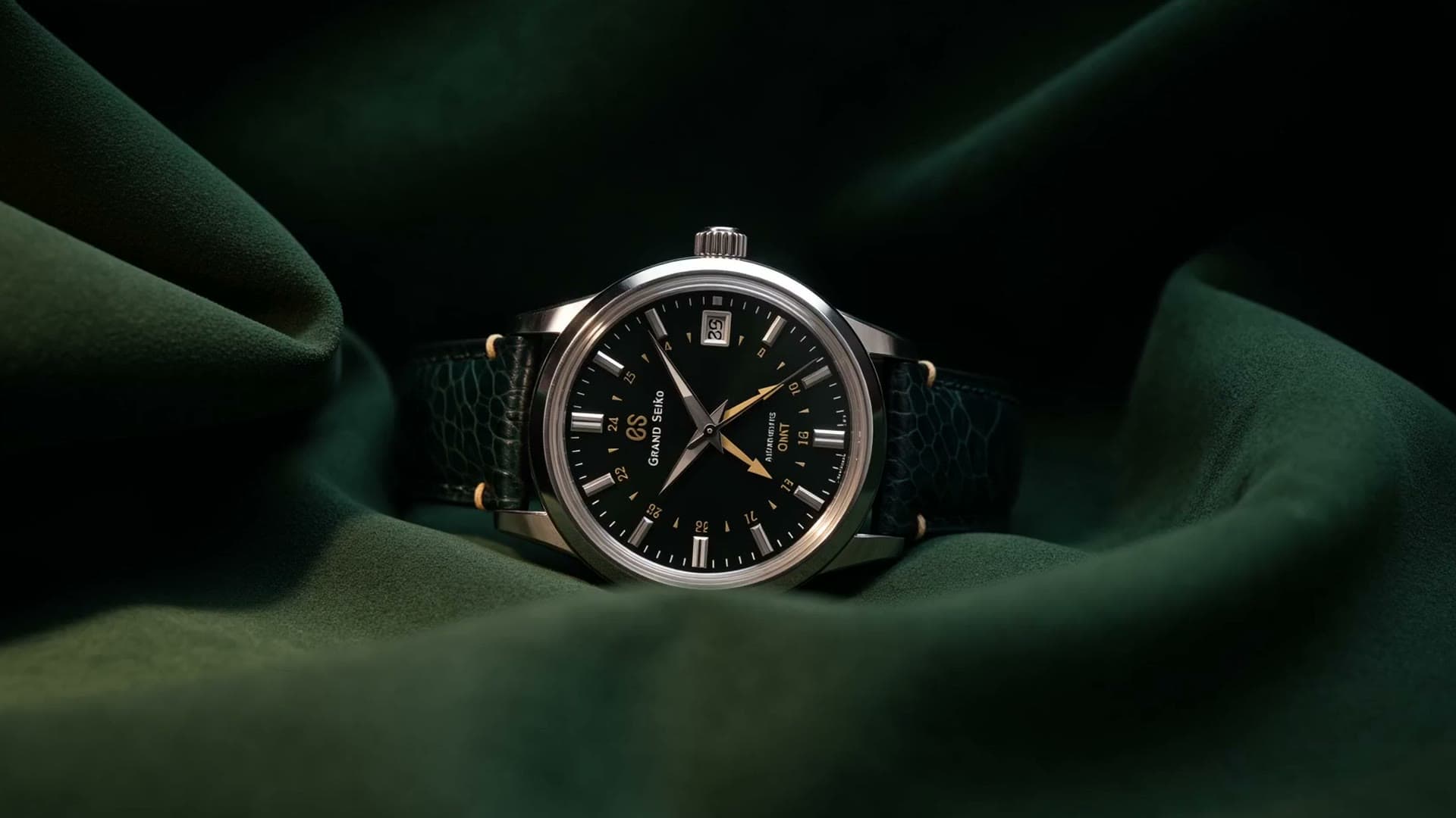 A Grand Seiko on a hand-stitched green exotic-leather strap, resting on deep-green velvet.